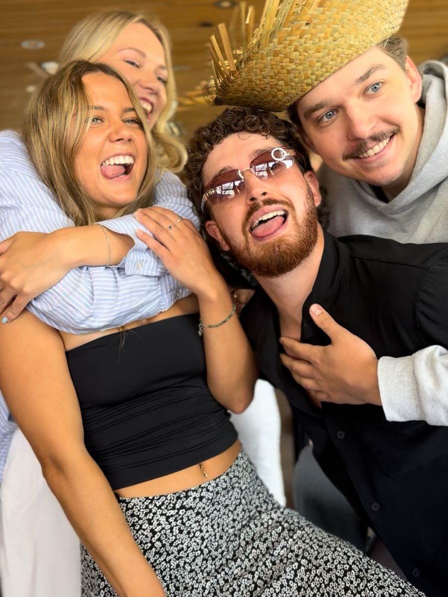 A fun group of young friends posing together in a photo booth in Kelowna.